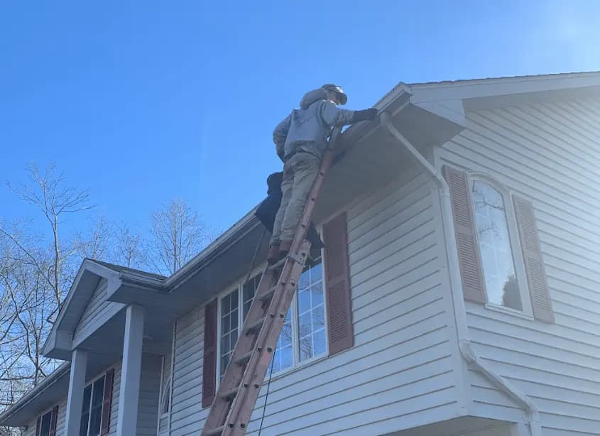 Gutter cleaning and maintenance being performed by Mentor Power Washing in Mentor