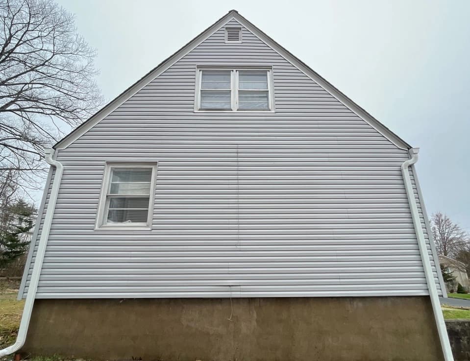 Mentor Power Washing technician performing detailed house washing in Mentor residential area